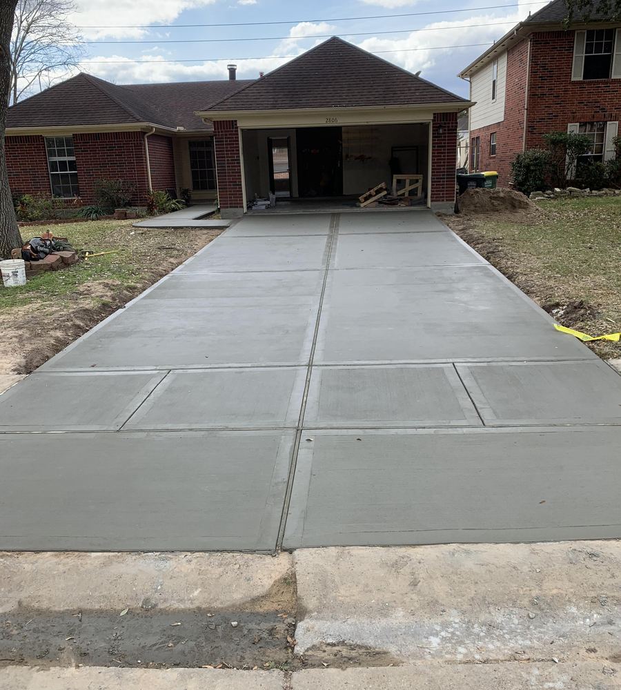 Finished concrete driveway at a brick home
