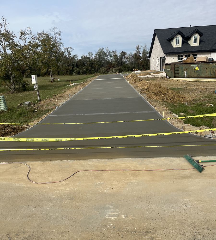 Finished long concrete driveway at a new home
