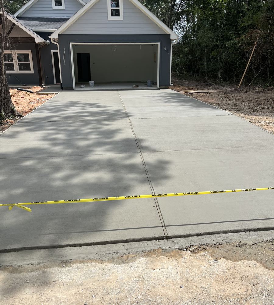 Finished wide concrete driveway at a new build home