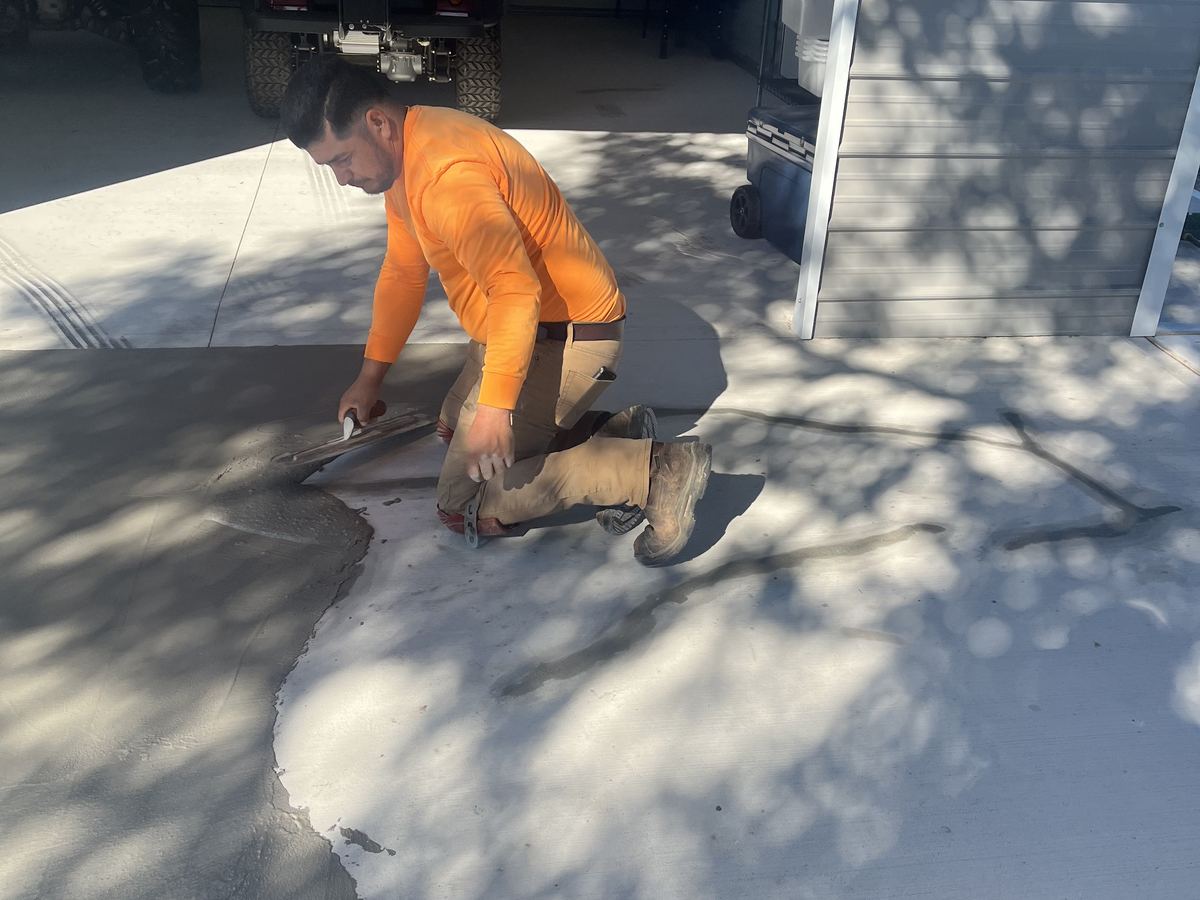 Aria Concrete crew member finishing a fresh slab