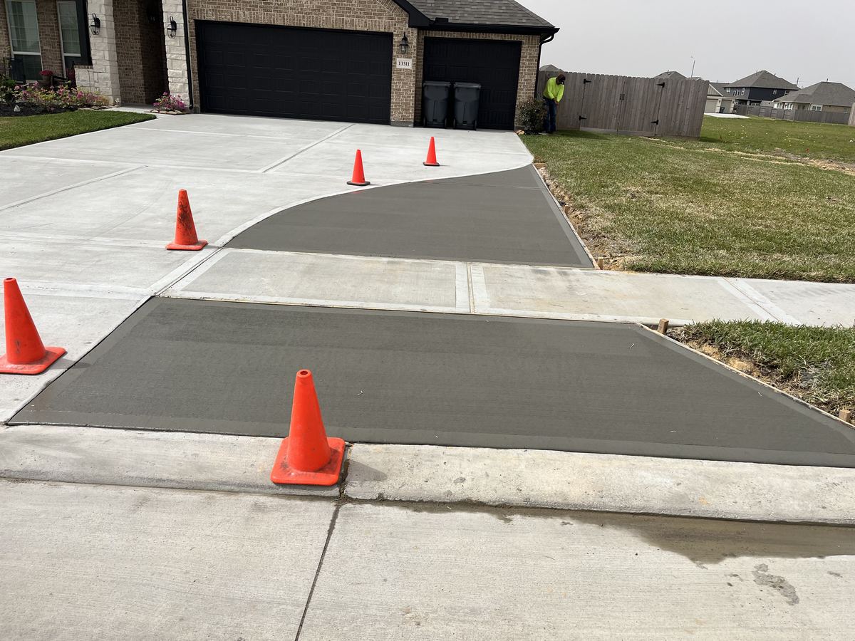 New concrete driveway extension with a widened approach