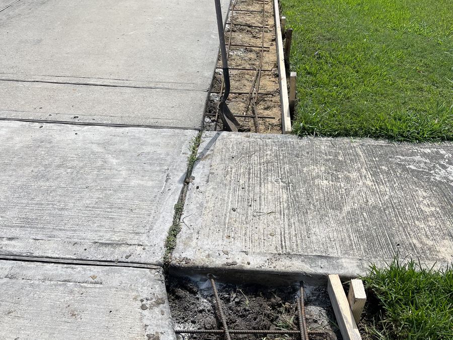 Old concrete cut out and removed beside a fresh pour